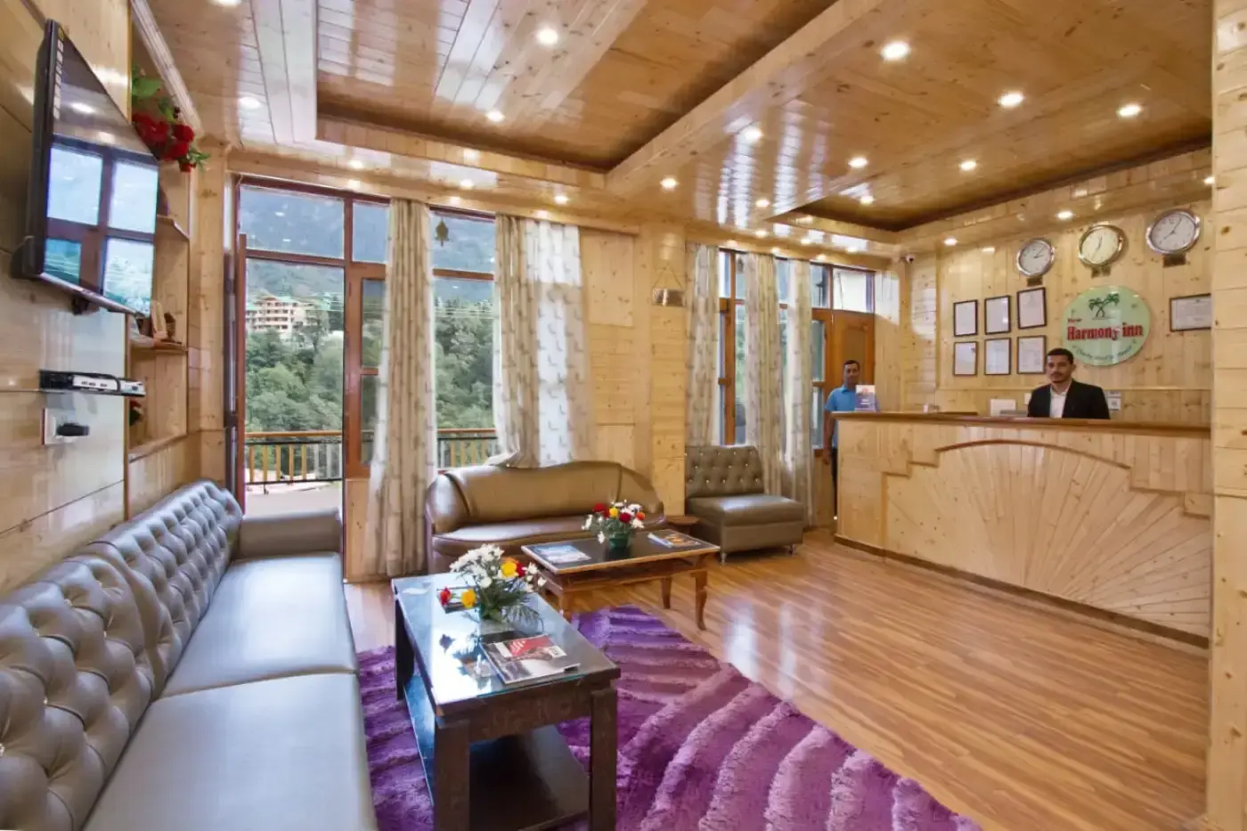 Harmony Inn lobby with wood paneling and mountain views